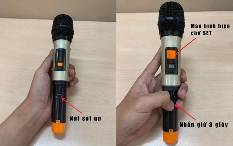 Bàn tay đang nhấn nút cài đặt tần số trên thân micro không dây, một bước quan trọng để thiết lập micro không dây với loa bluetooth.