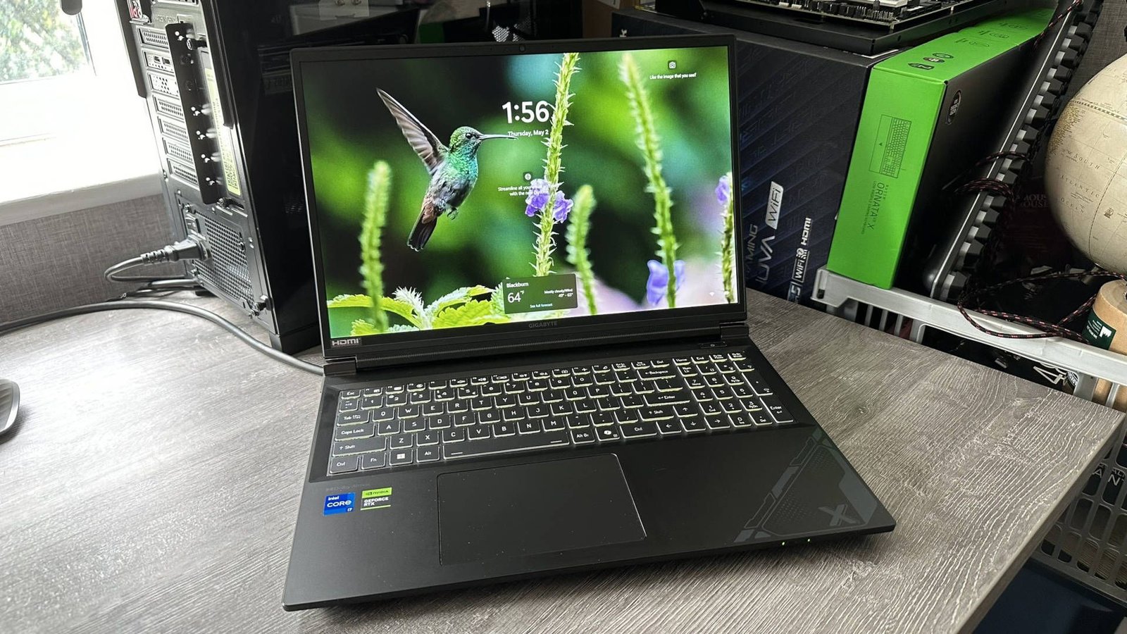 Hình ảnh laptop chơi game Gigabyte G6X màu xám kim loại, nhìn từ phía bên phải, với các cổng kết nối và khe thoát nhiệt