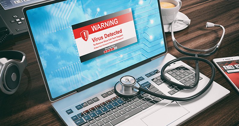 Hình ảnh laptop đang hiển thị cảnh báo virus hoặc phần mềm độc hại