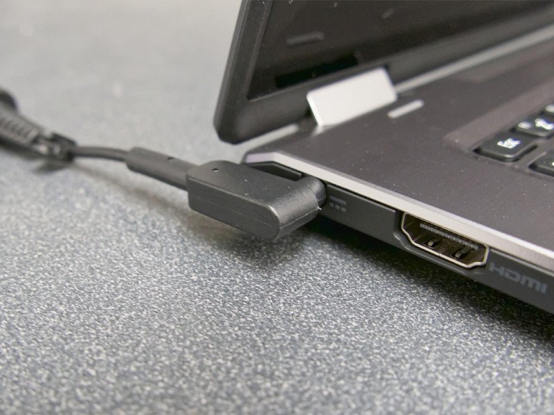 Laptop đang được cắm sạc và sử dụng, pin hiển thị đầy