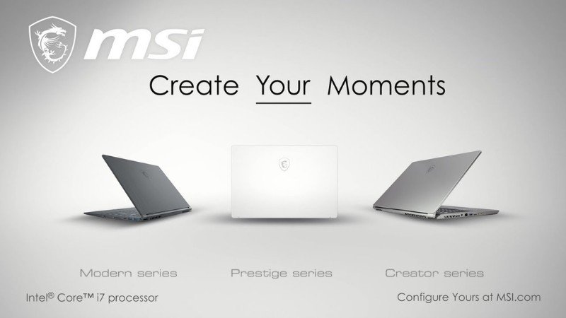 Một chiếc laptop MSI màu xám đen, màn hình sáng hiển thị các ứng dụng đồ họa