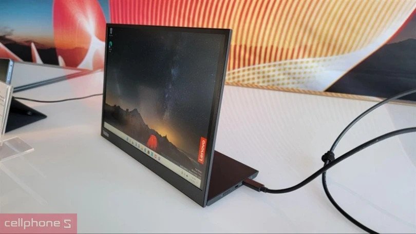 Một người đang làm việc với màn hình phụ di động cho laptop trong môi trường văn phòng gọn gàng