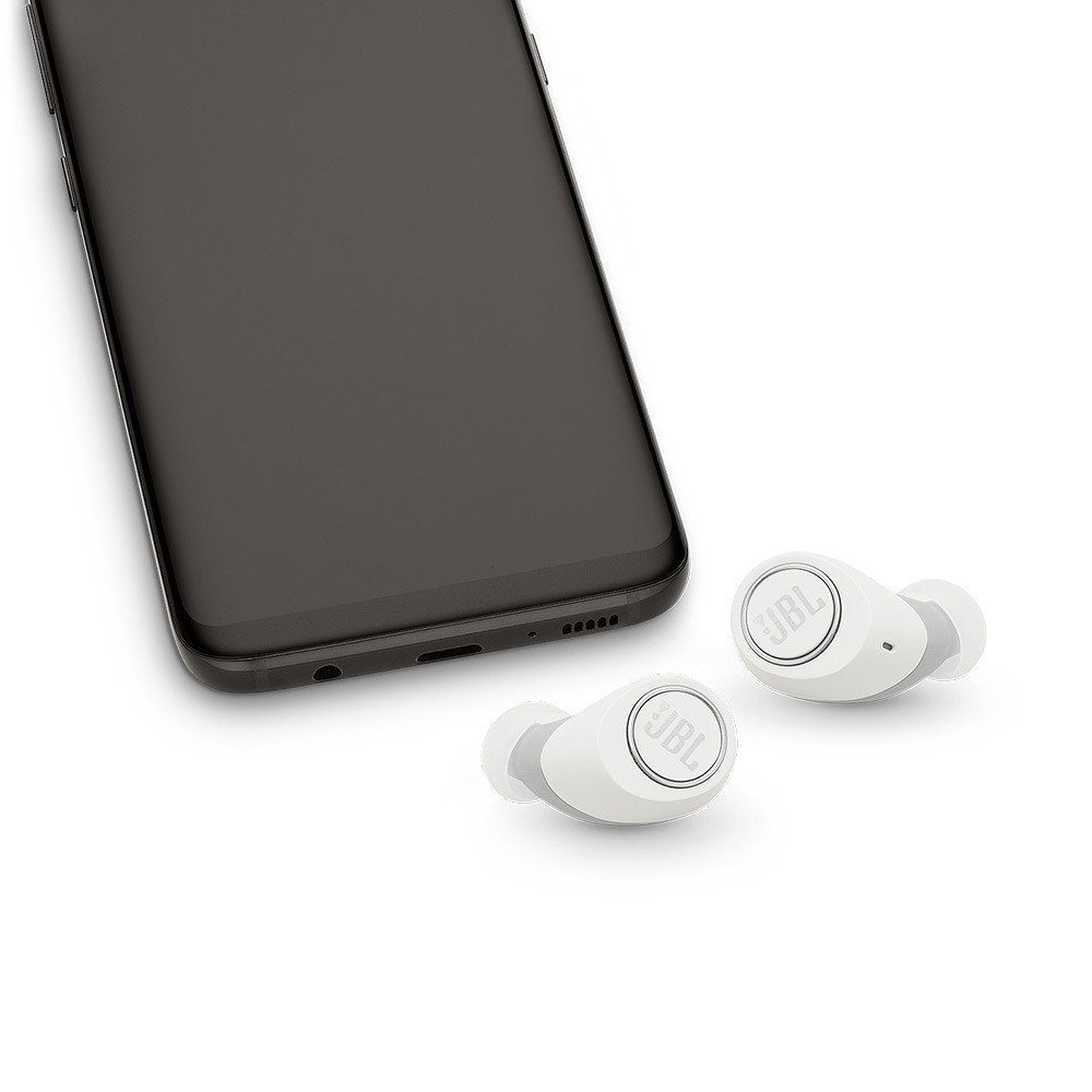 Một tai nghe JBL Free màu trắng đang được đeo trên tai người dùng, thể hiện sự vừa vặn và thẩm mỹ