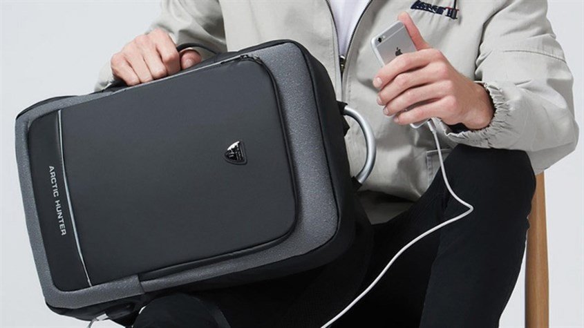 Người dùng đang kiểm tra chất liệu và khả năng chống sốc của balo dành cho laptop 16 inch.