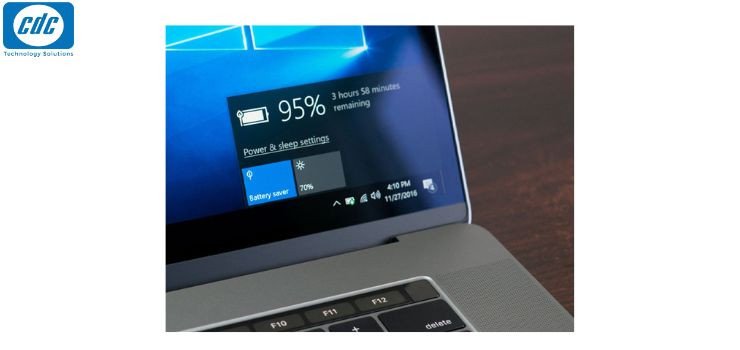 Người dùng đang vừa sạc vừa dùng laptop Dell trên bàn làm việc